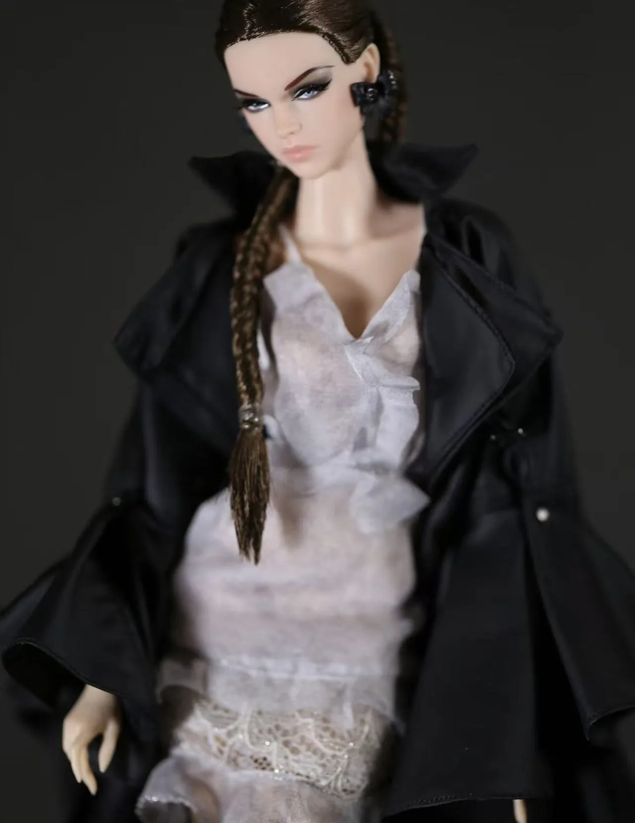 H Factor fashion doll with a long brown braid in a black satin trench coat over a white lace dress